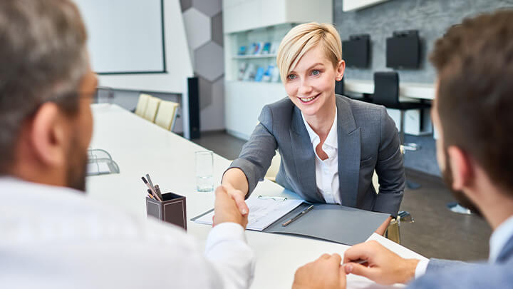 Interviewer shaking hands with interviewees