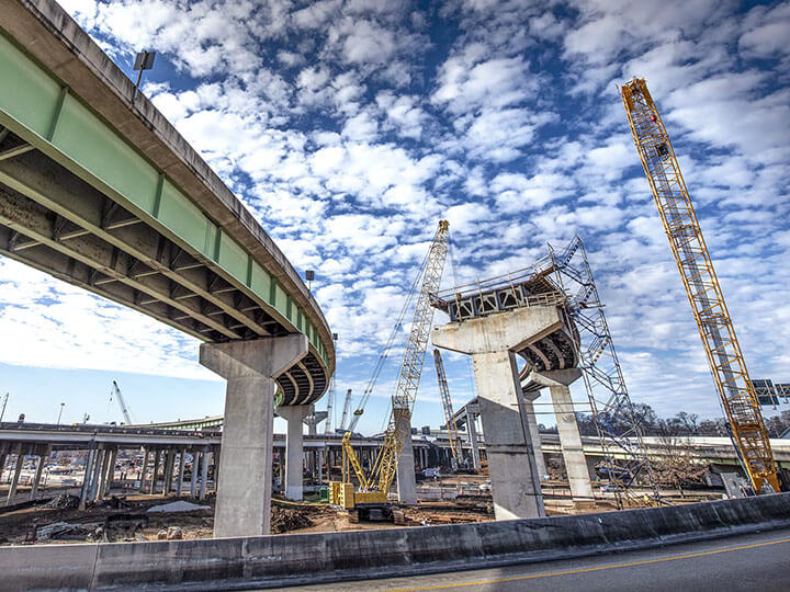 Intertek PSI Infrastructure Solutions with construction on a highway overpass bridge that is half complete