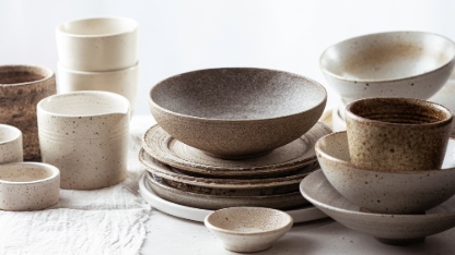 handmade ceramic tableware, empty craft ceramic plates, bowls and cups on light background 