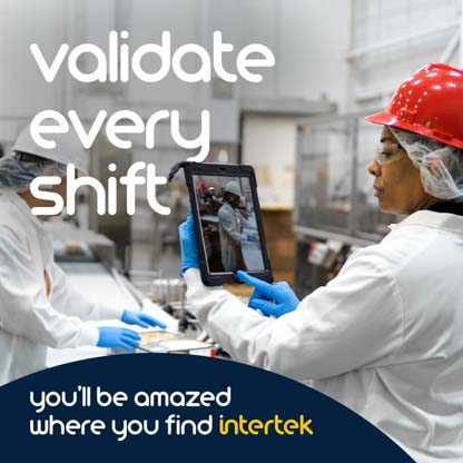 A worker in a lab consulting an electronic tablet
