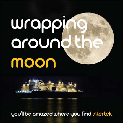 A full moon above a LNG transport ship at night
